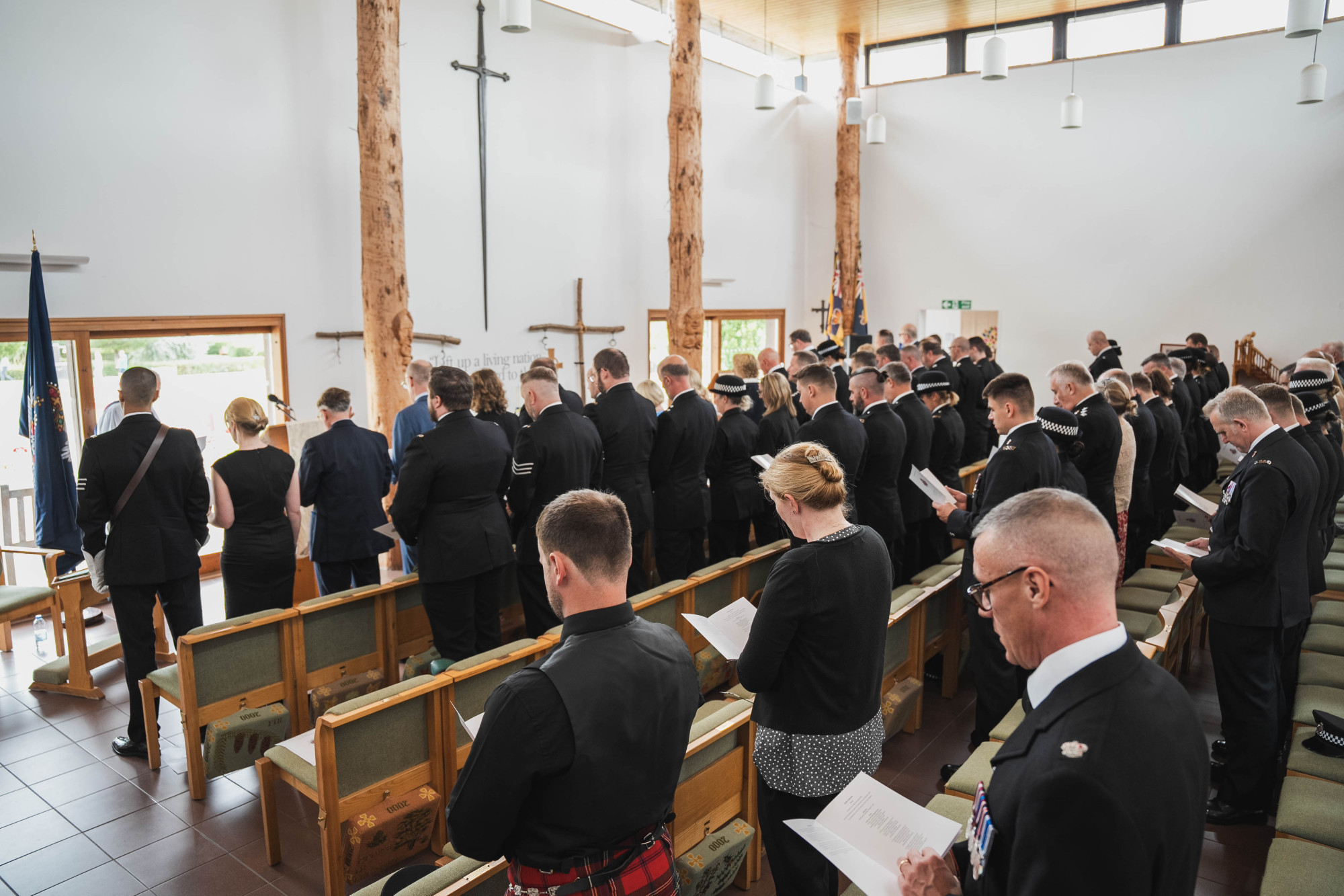 Officers, staff and guests take part in the service