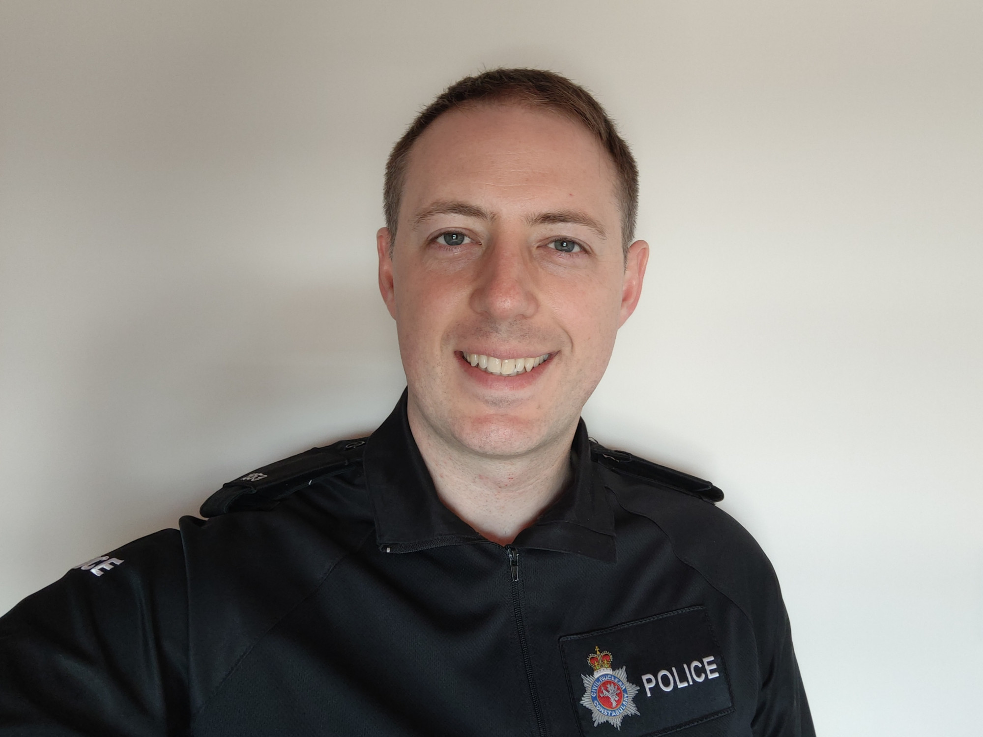Craig Robertson is pictured in his black police uniform